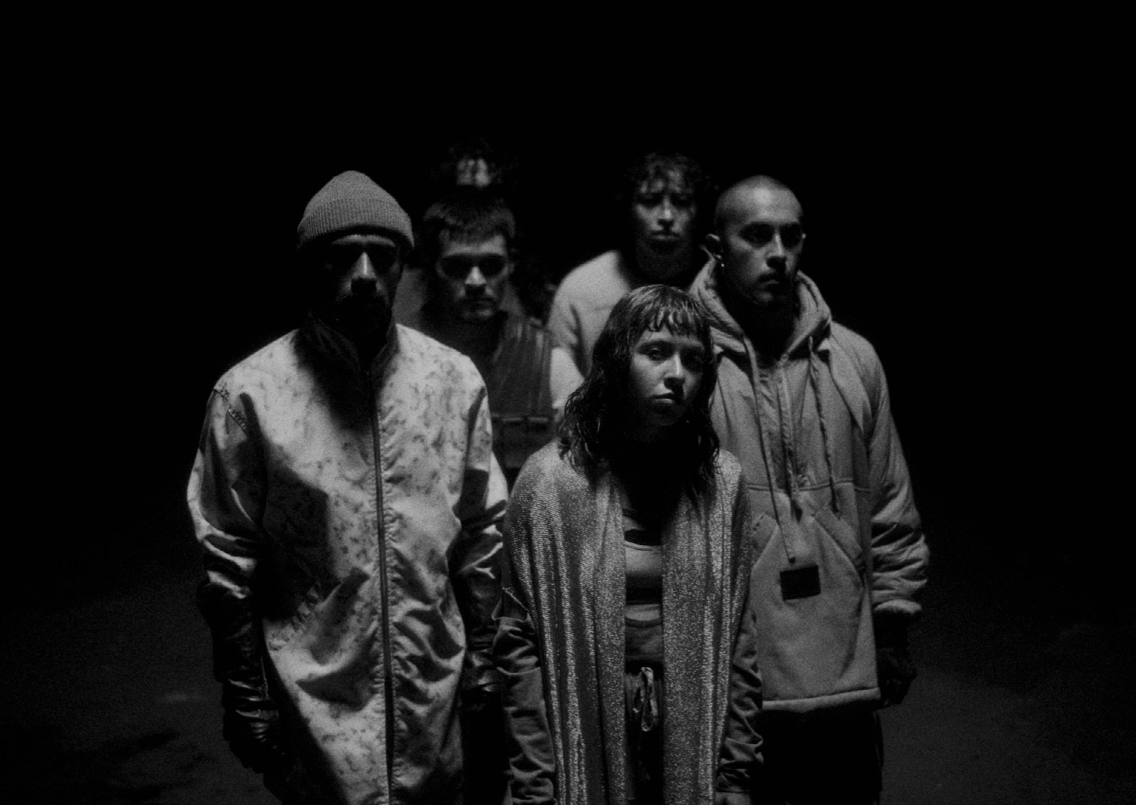 Six dancers performing in monochrome interior, photographed close and intimate